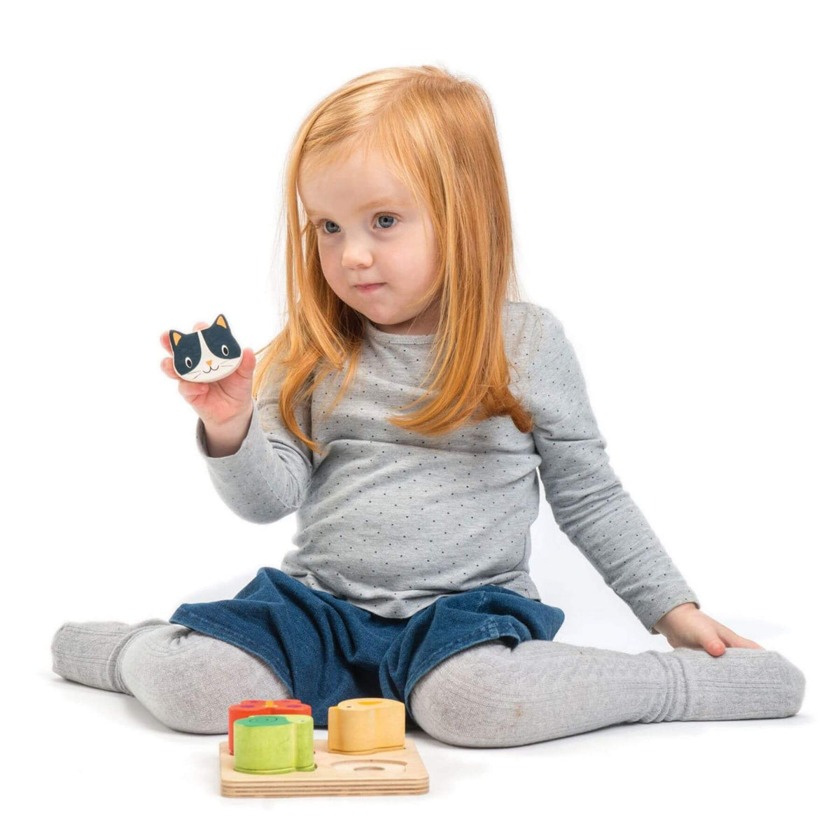 Child playing with wooden toys on a white background