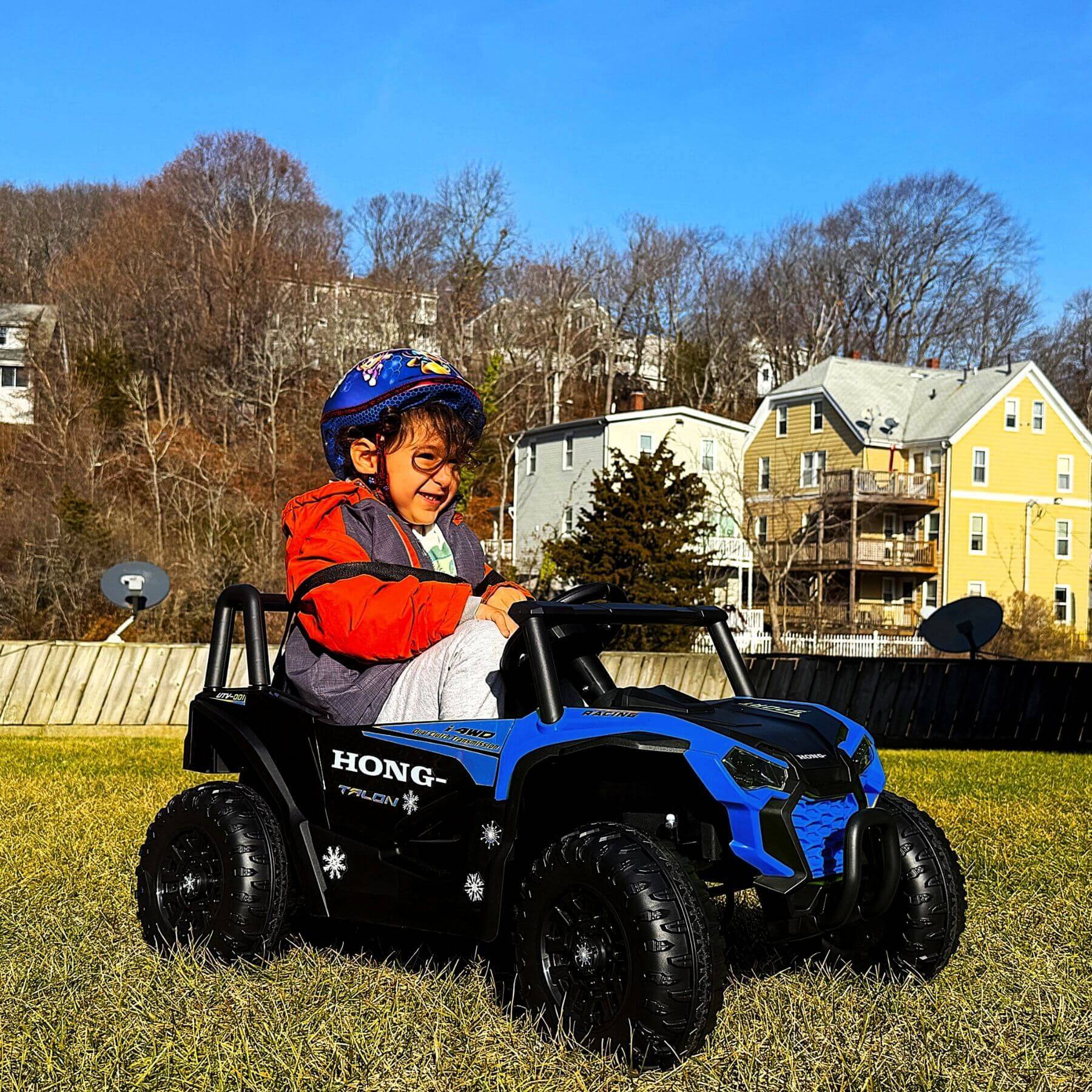 Kid playing Tamco 12V Ride On UTV Toy Electric Car Blue