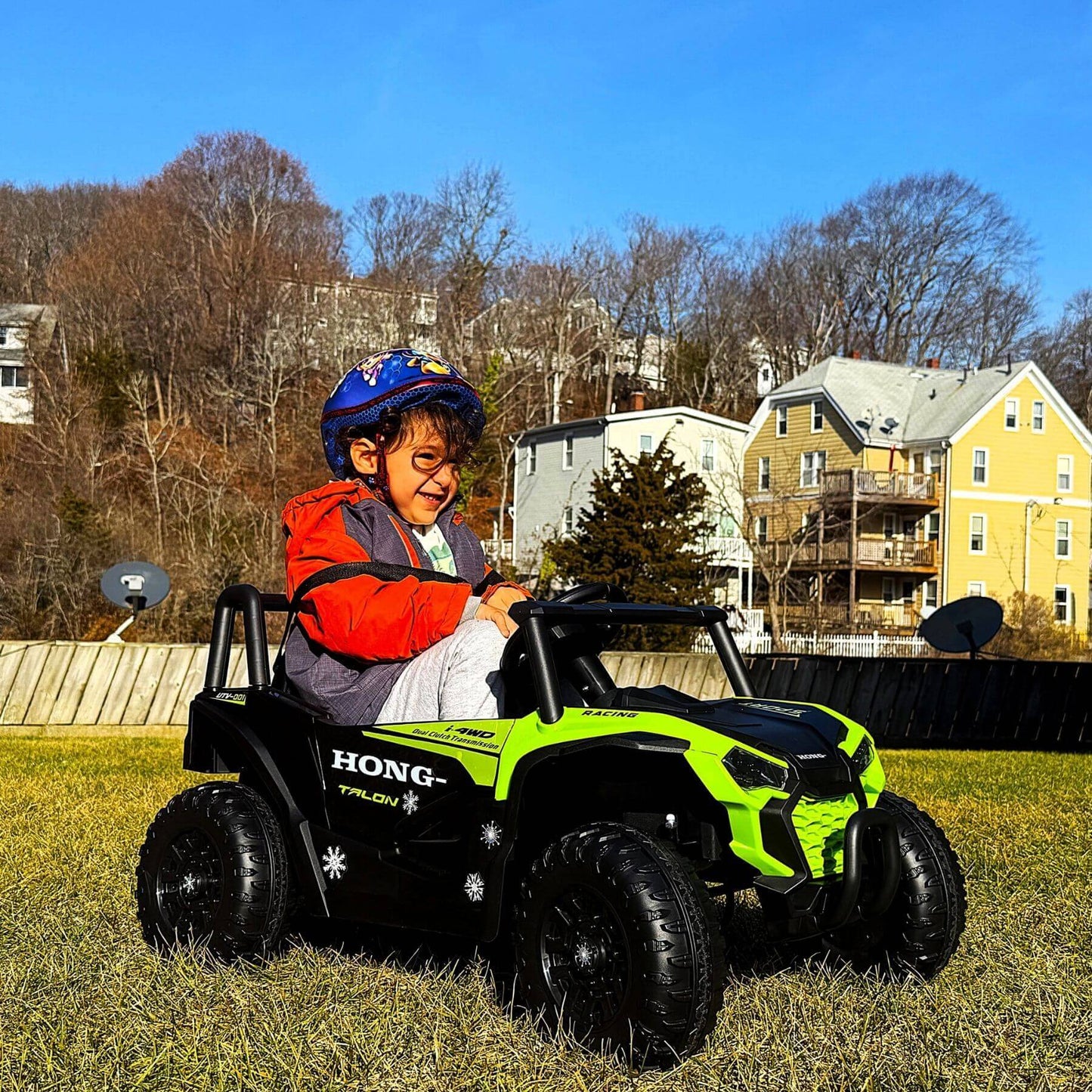 Kid playing Tamco 12V Ride On UTV Toy Electric Car Green
