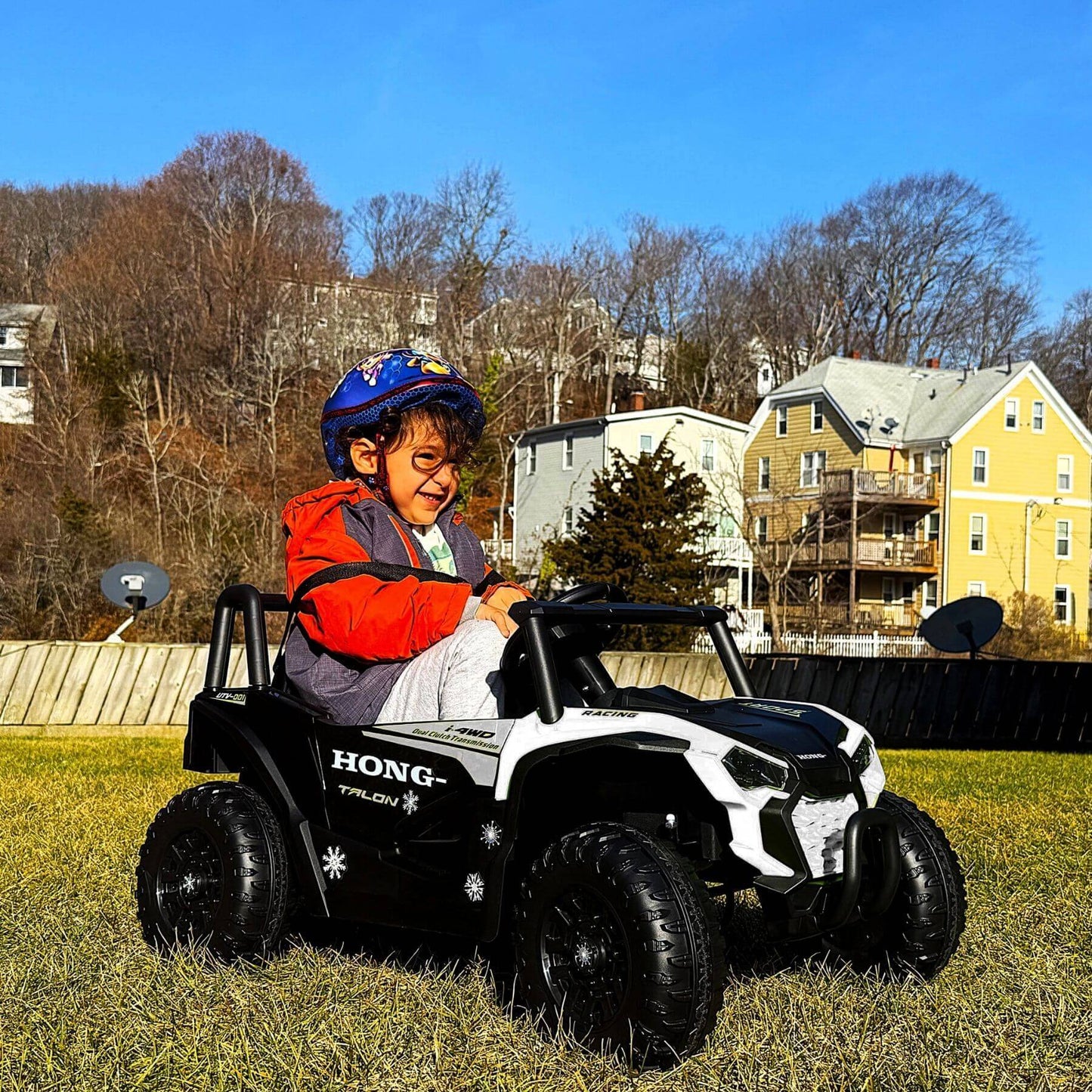 Kid playing Tamco 12V Ride On UTV Toy Electric Car White