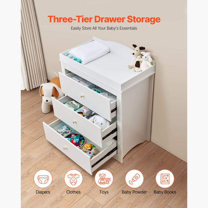 White three-tier drawer storage unit with baby items on a wooden floor.