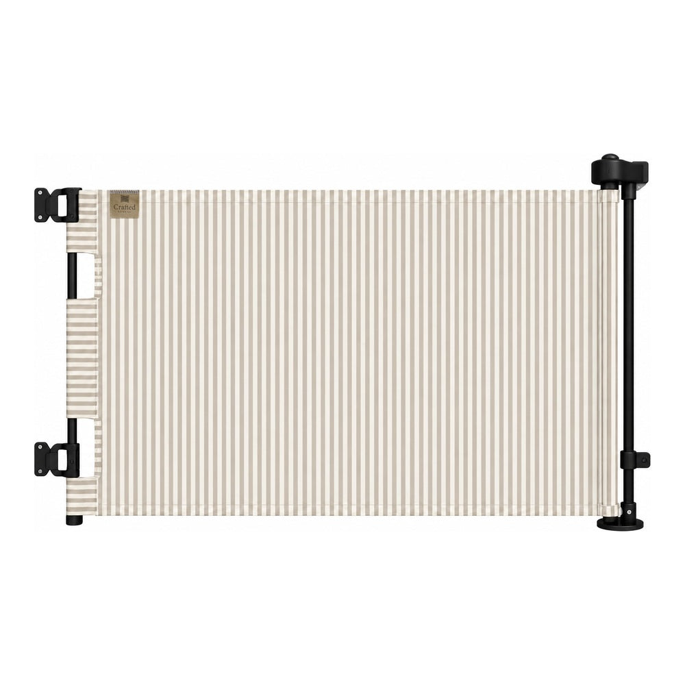 A retractable patio canopy with beige and white vertical stripes, mounted on a black metal frame with mounting brackets on a white background.