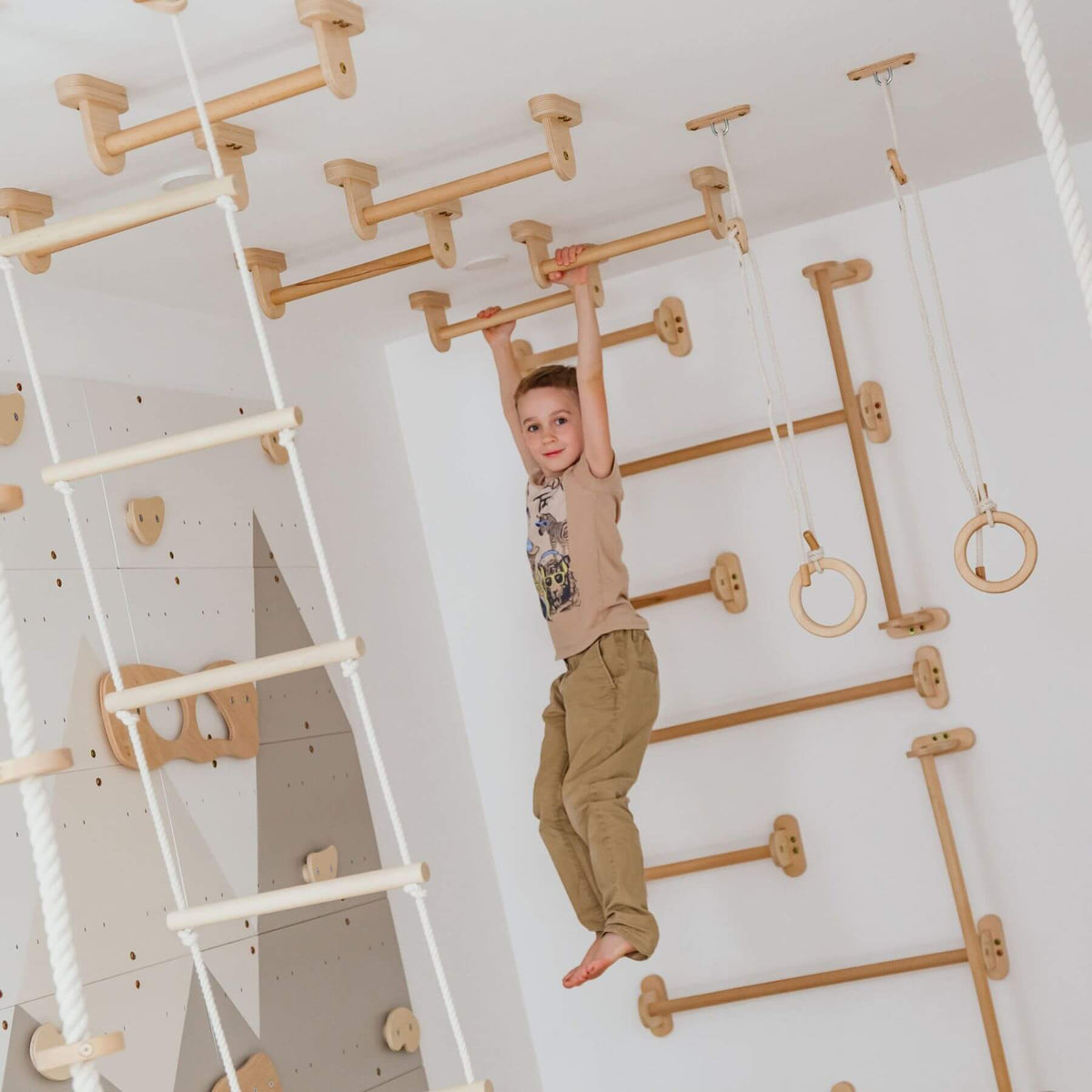 Child climbing on Wood and Hearts Climbing Wall Playground