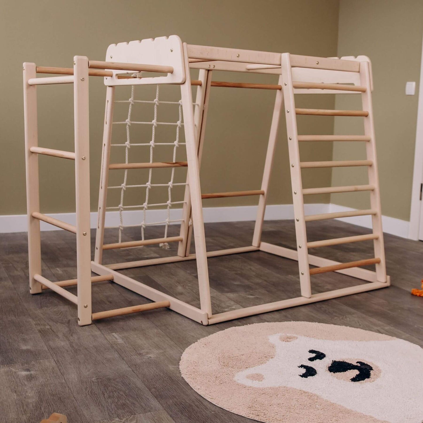 Wood and Hearts Jungle Gym Playset on a wooden floor.