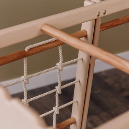 Wooden climbing frame with rope netting on a blurred background