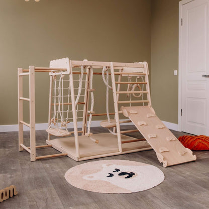 Wood and Hearts Jungle Gym Playset in a room.