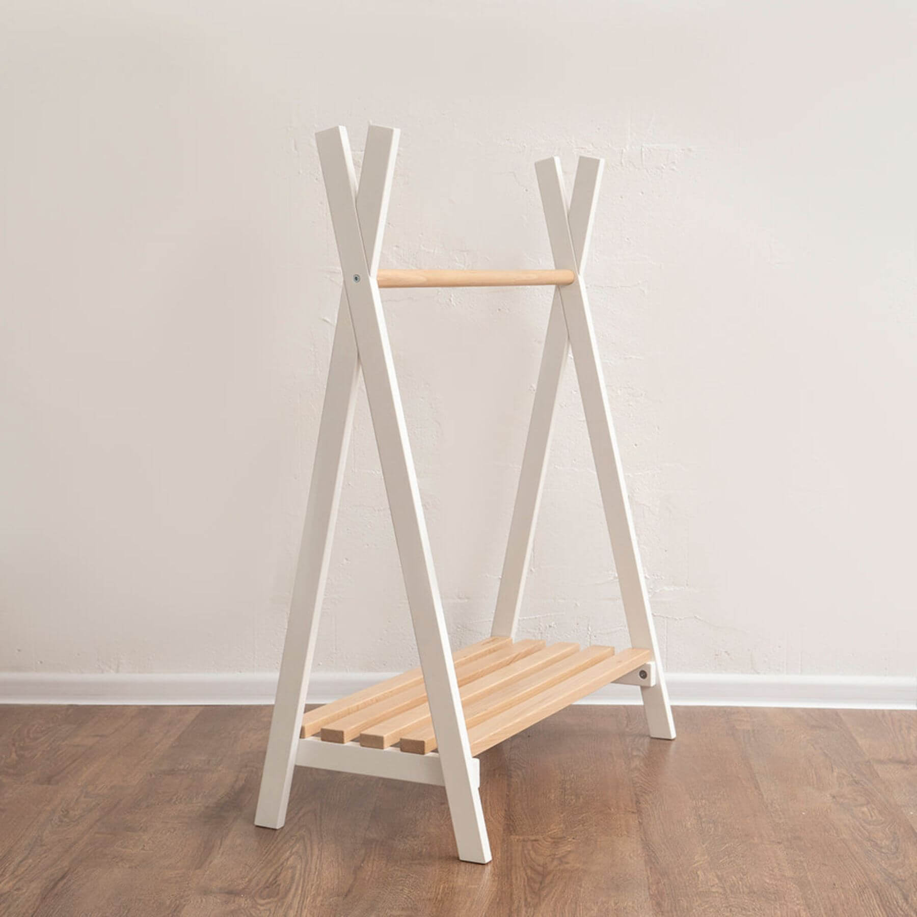 Wood and Hearts Toddler's Clothes Rack on a wooden floor against a white wall