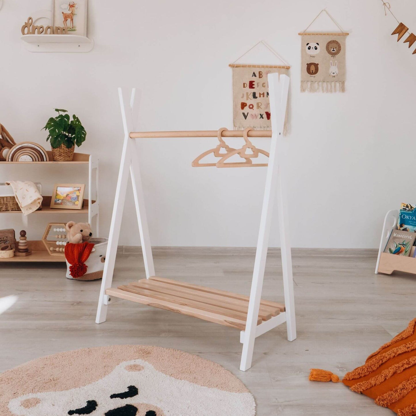 Wood and Hearts Toddler's Clothes Rack in a nursery with decor elements.