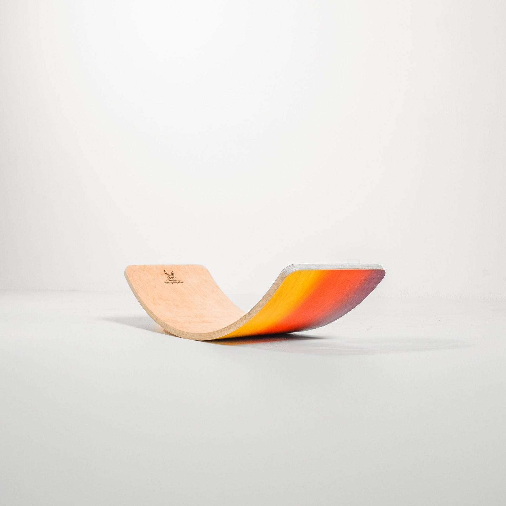 Bunny Hopkins Wobble Board - Sunset on a light gray background