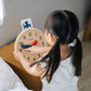 Girl Playing PlanToys Activity Clock