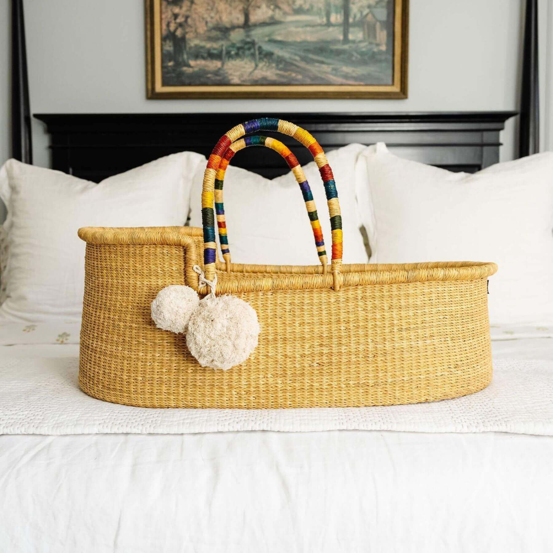 Plum+Sparrow African Moses Basket Rainbow Vegan Handle on a bed