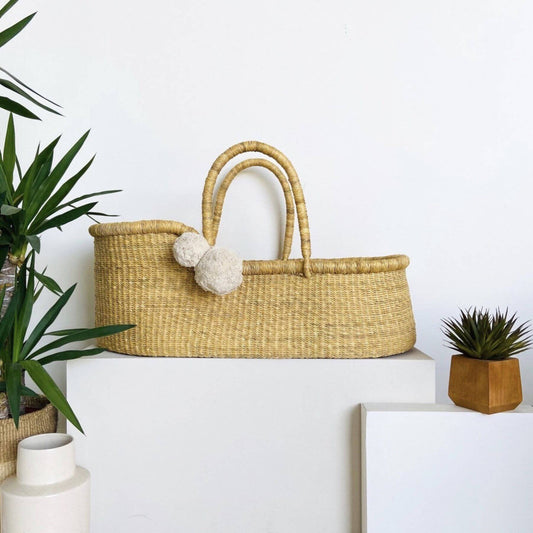 Plum+Sparrow African Moses Basket Vegan Handle on a white surface with plants and a framed picture.