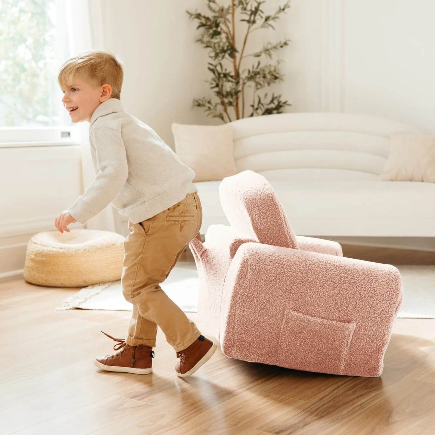 Boy Pulling Tiny Land® Afternoon Couch —— Pink Kids Chair