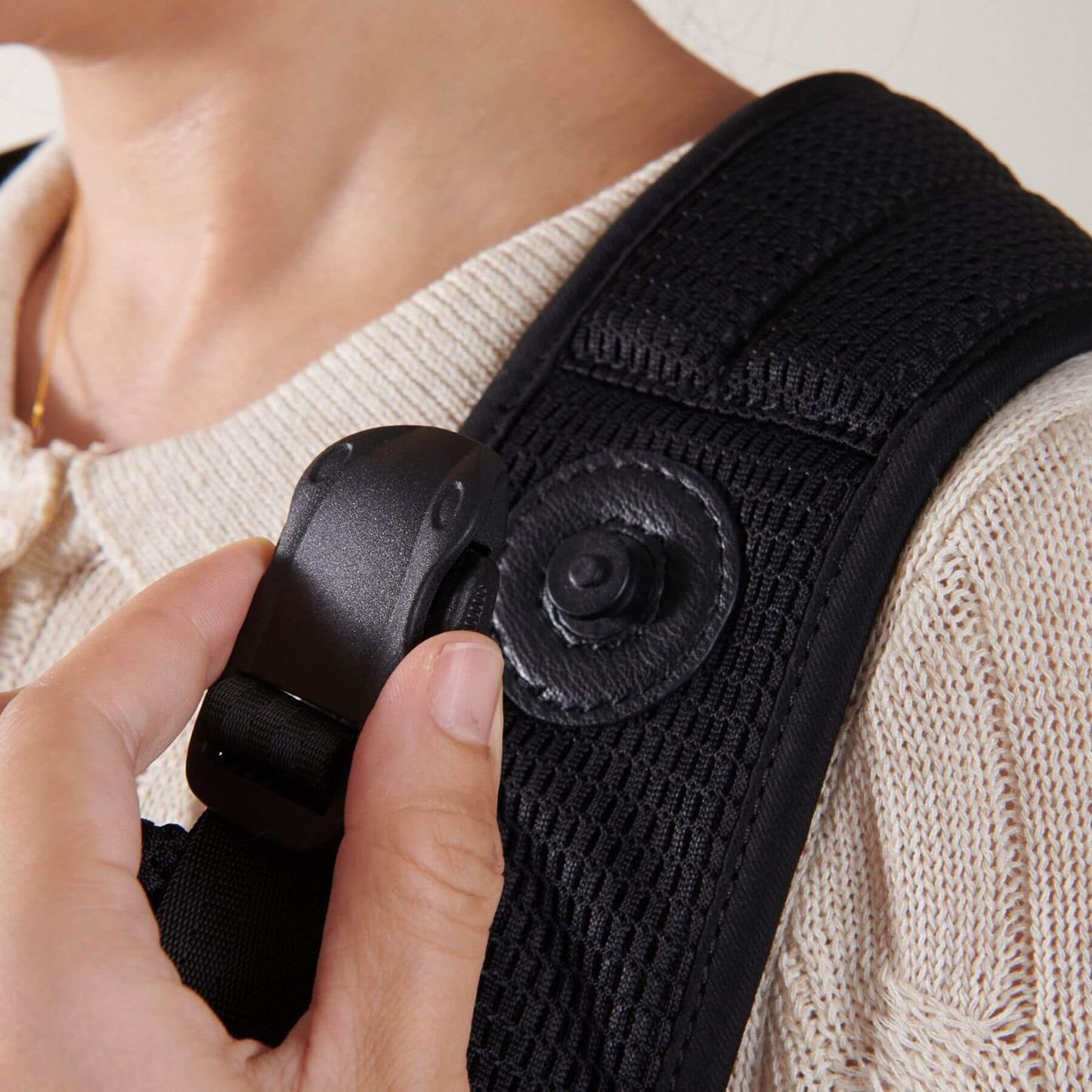 Close-up of a person adjusting Sunveno All-in-One Baby Carrier