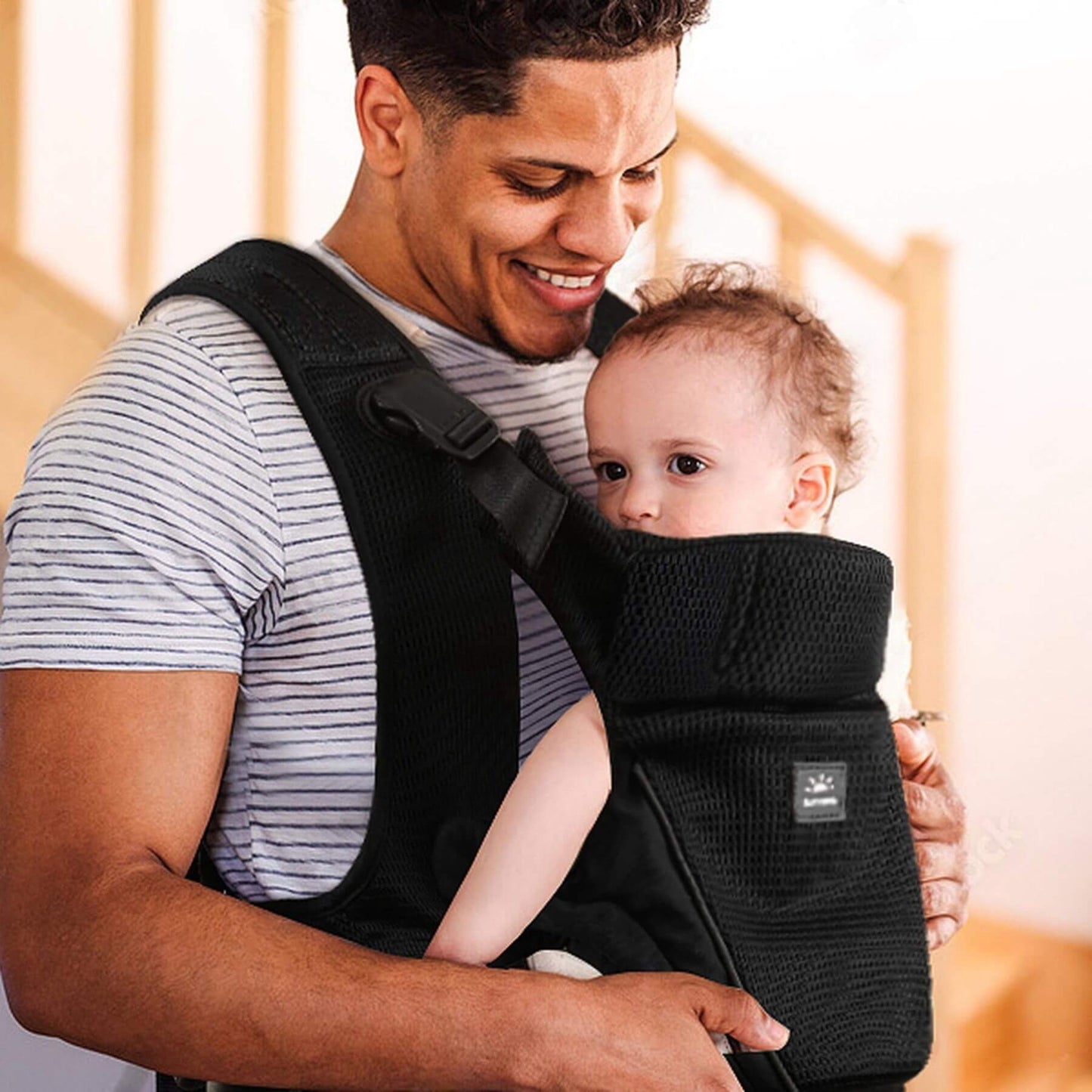 Man holding a baby in Sunveno All-in-One Baby Carrier