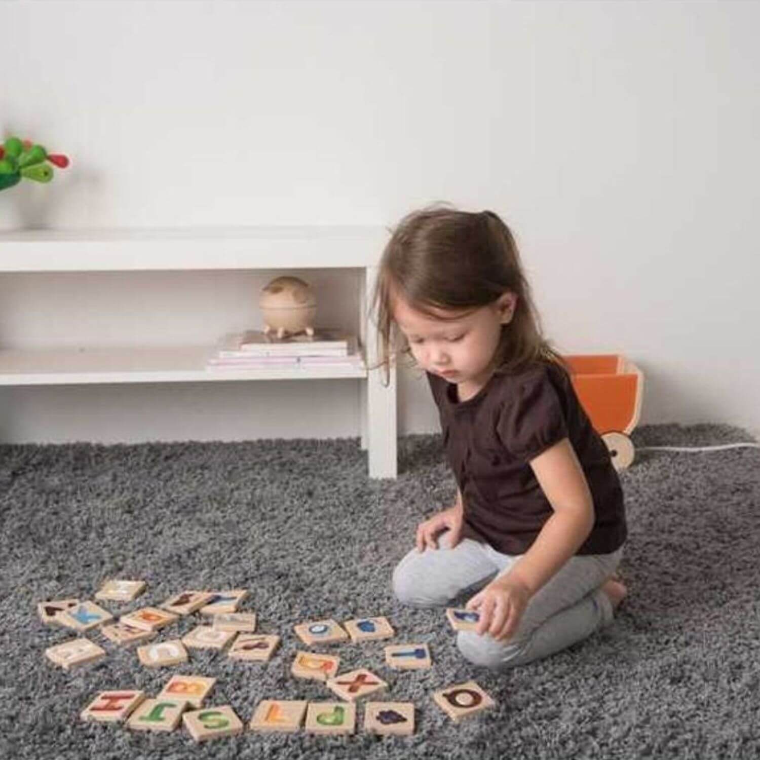 Girl Playing PlanToys Alphabet A-Z Gradient Tiles