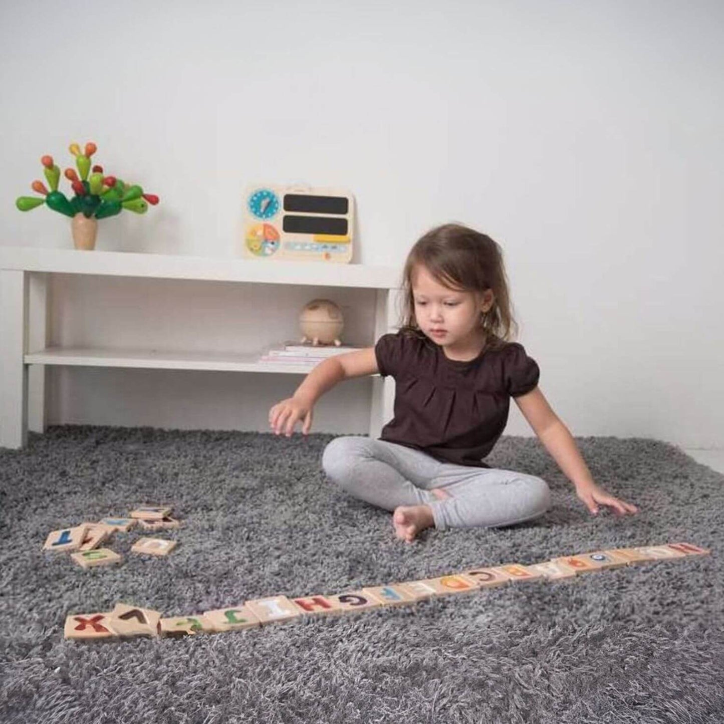 Girl Playing PlanToys Alphabet A-Z Gradient Tiles