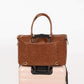 Freshly Picked Amber Minimal Weekender on top of a pink suitcase