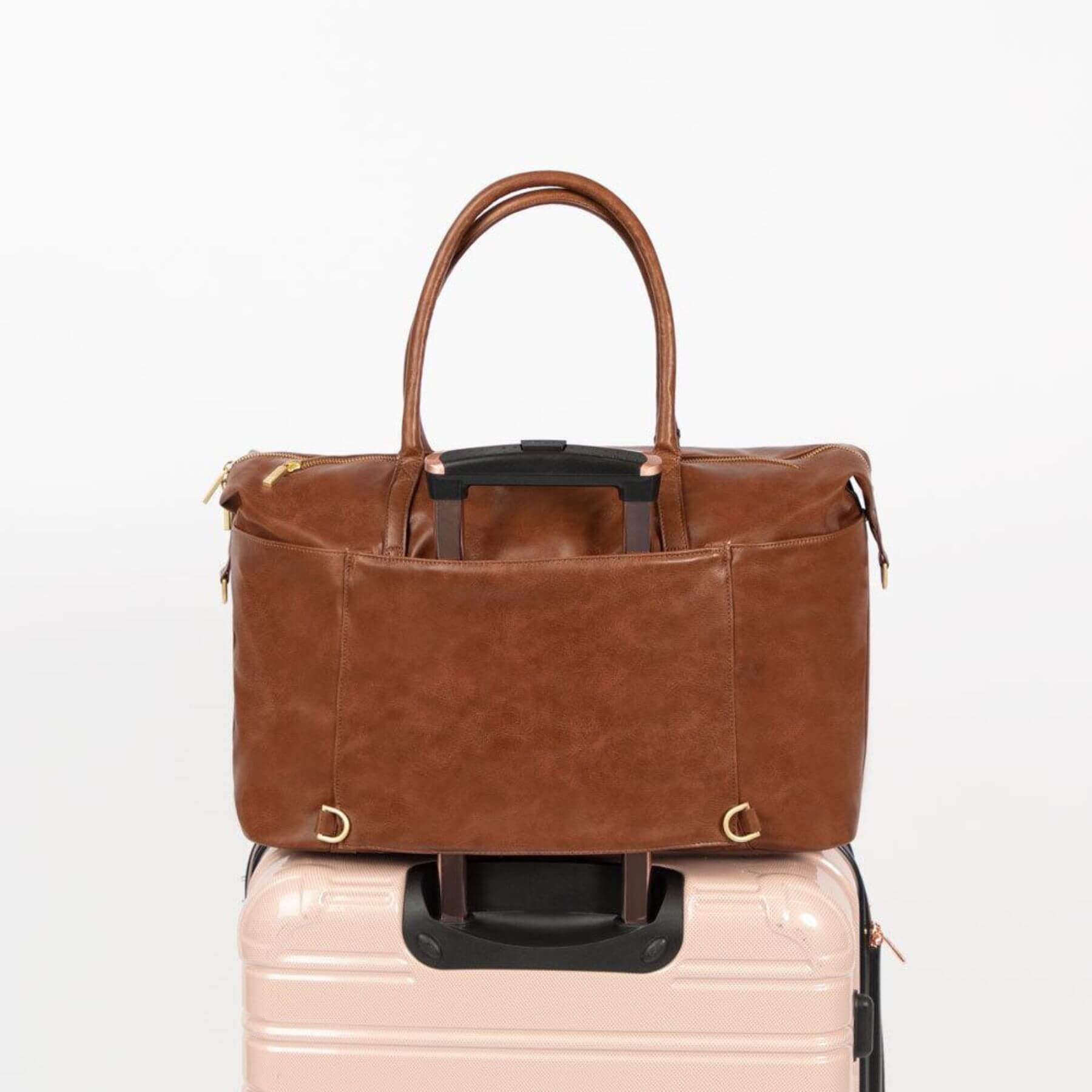 Freshly Picked Amber Minimal Weekender on top of a pink suitcase