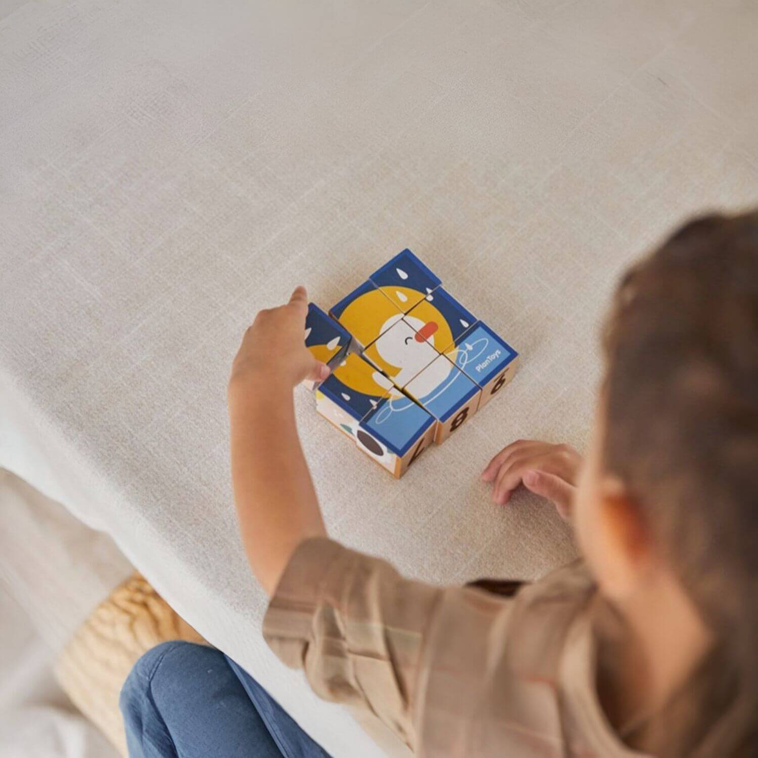 Boy Playing PlanToys Animal Puzzle Cubes