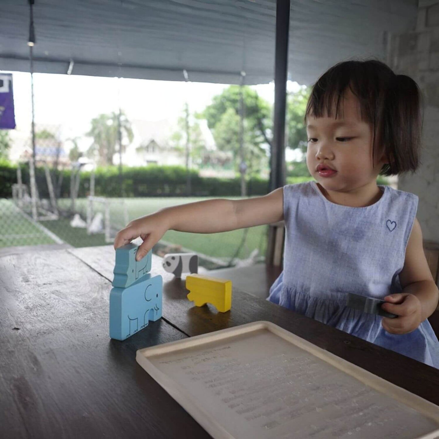 Girl Playing PlanToys Animal Puzzle Game