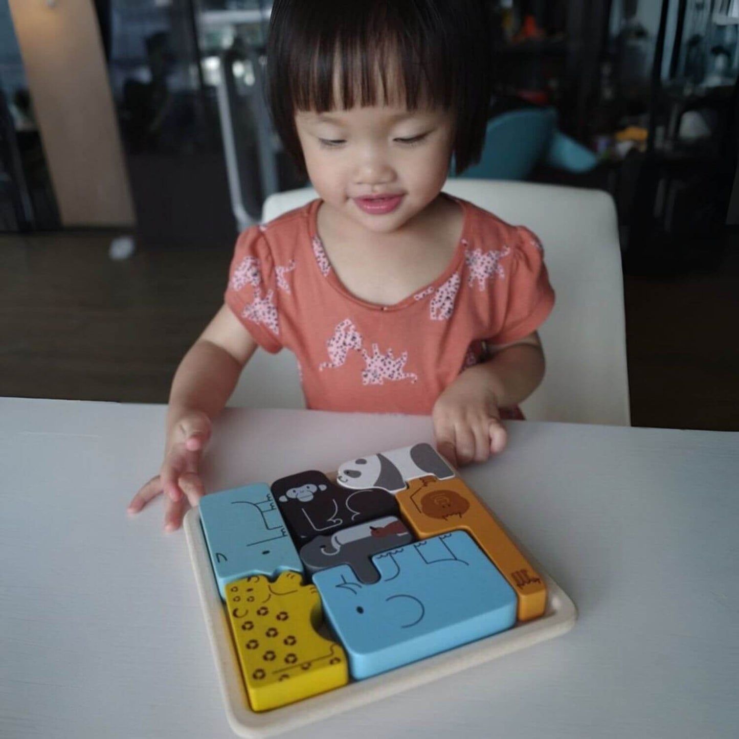 Girl Playing PlanToys Animal Puzzle Game