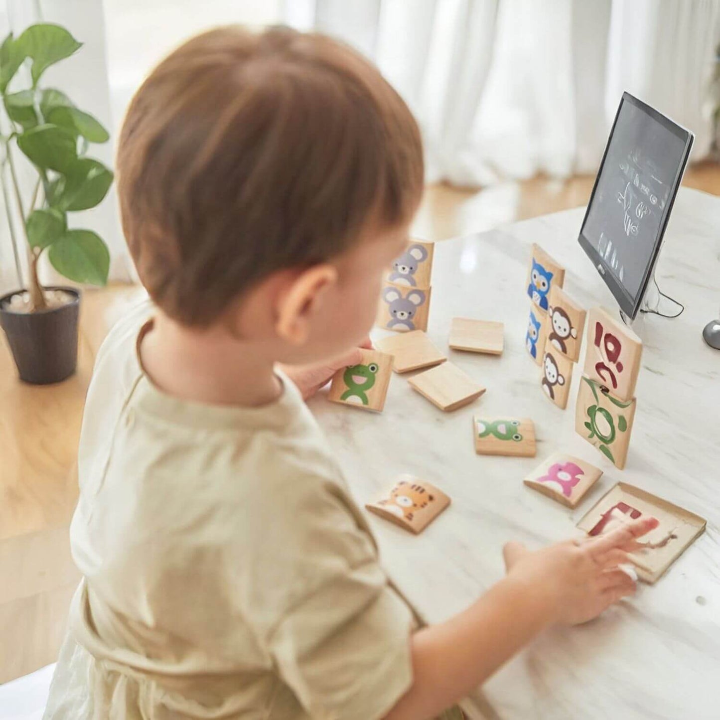 Kid Playing PlanToys Animals Memo