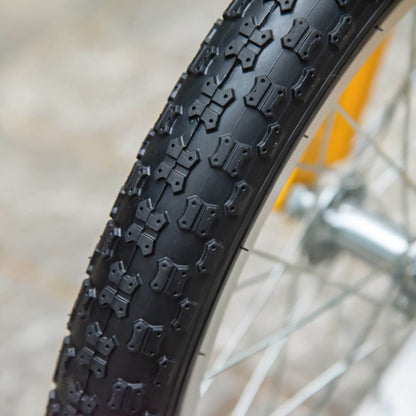 Close-up of a bicycle tire with tread pattern on a blurred background