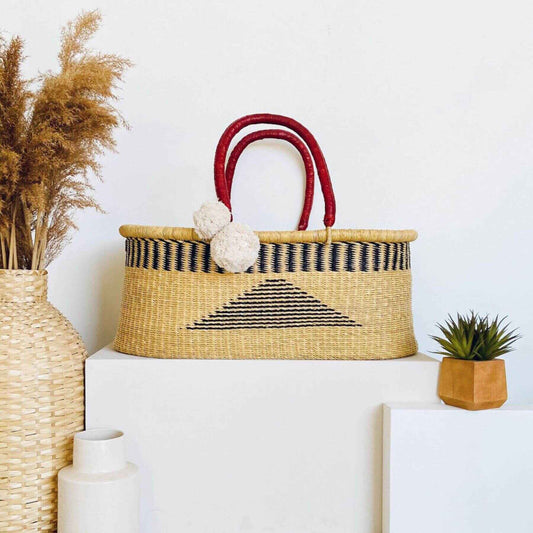 Plum+Sparrow Artisan Sky No Hood African Moses Basket on a white surface with decorative elements.