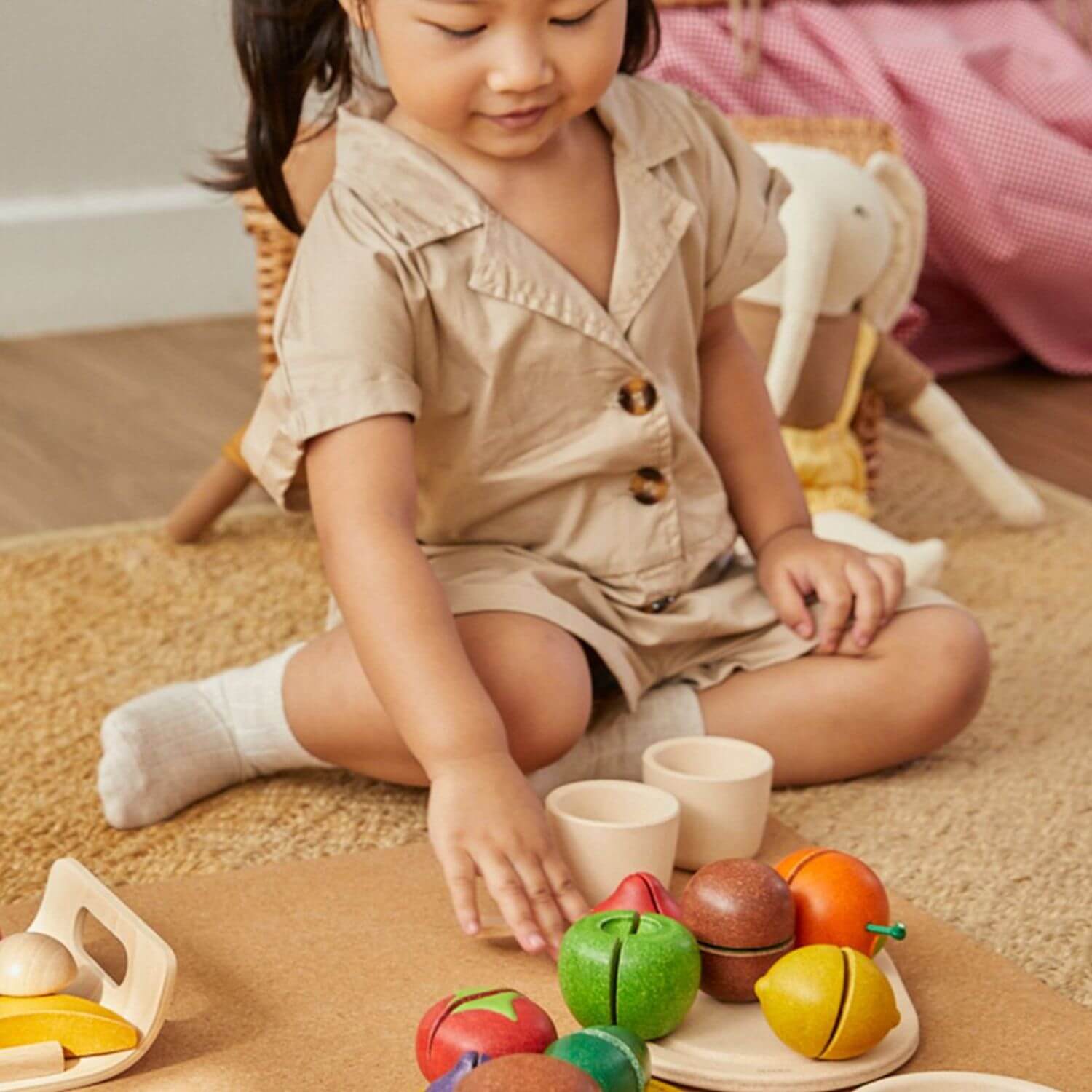 Girl Playing PlanToys Assorted Fruit Set