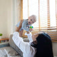 Mom Holding Baby, Playing PlanToys Baby Car