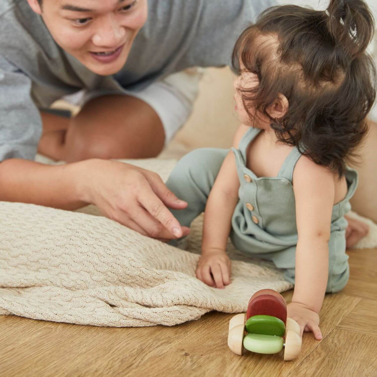 Dad & Baby Playing PlanToys Baby Car - Modern Rustic