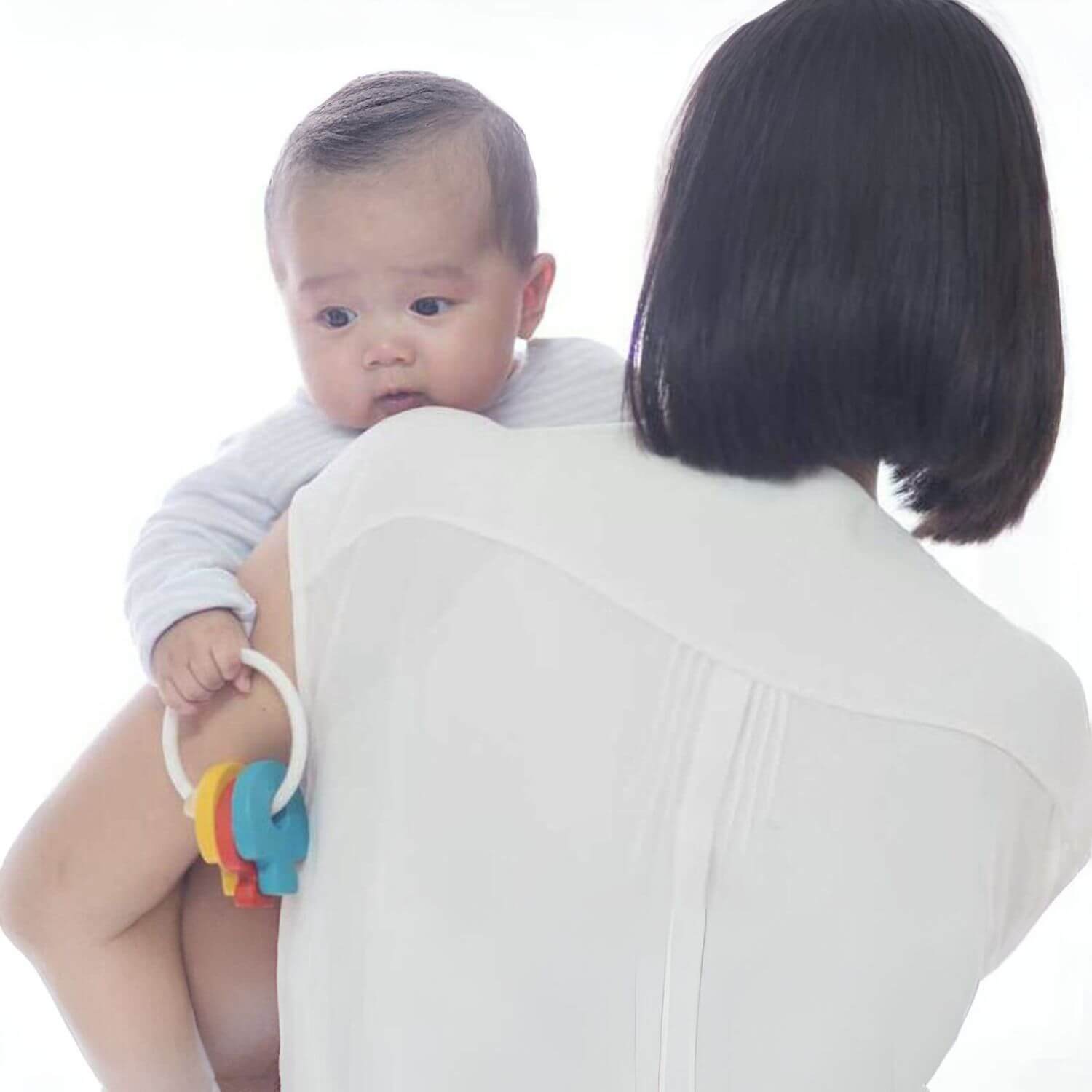 Mom Holding Baby, Playing PlanToys Baby Key Rattle