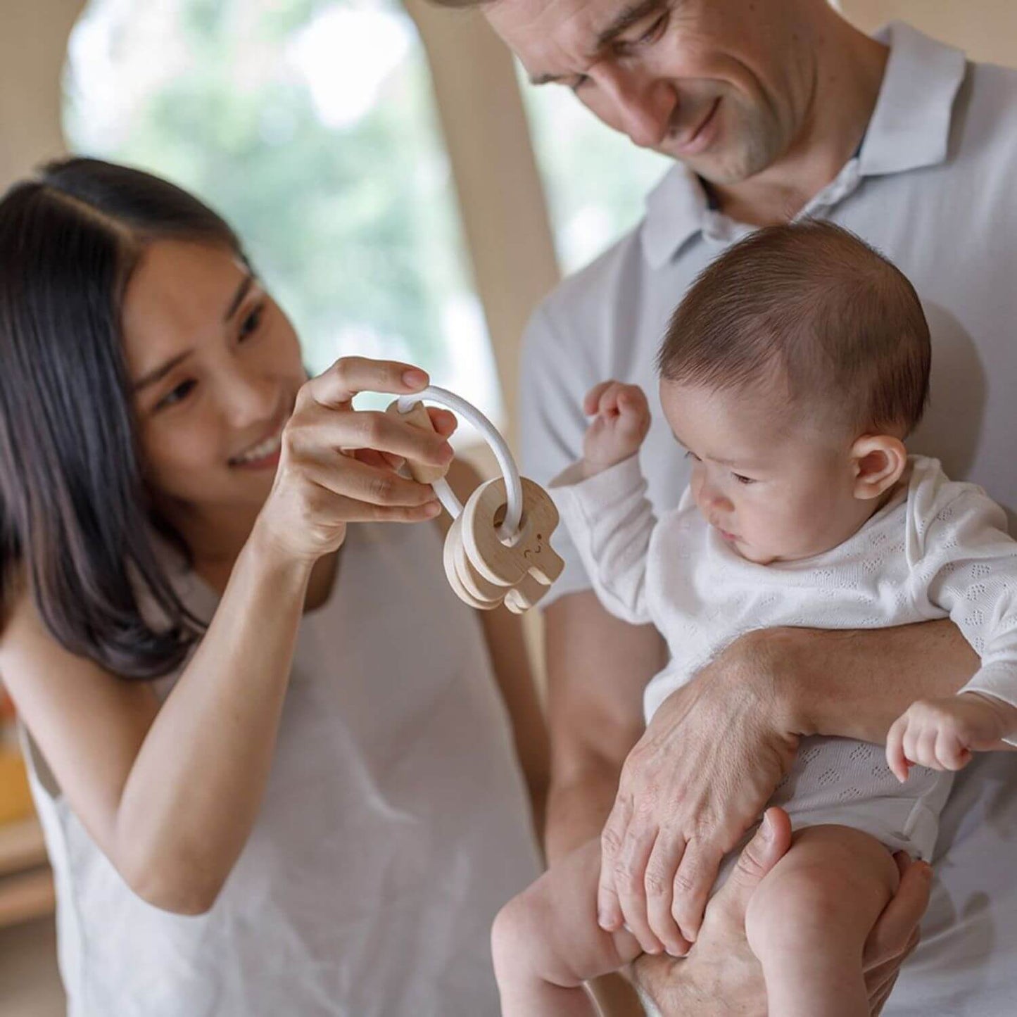 Parents and Baby Playing PlanToys Baby Key Rattle - Natural