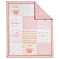 Pink baby quilt with heart and love designs on a white background