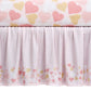 Crib skirt with heart pattern on a white background