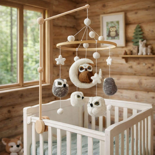 Baby crib with Ganapati Crafts Co. Baby Mobile - Owl in a wooden room.