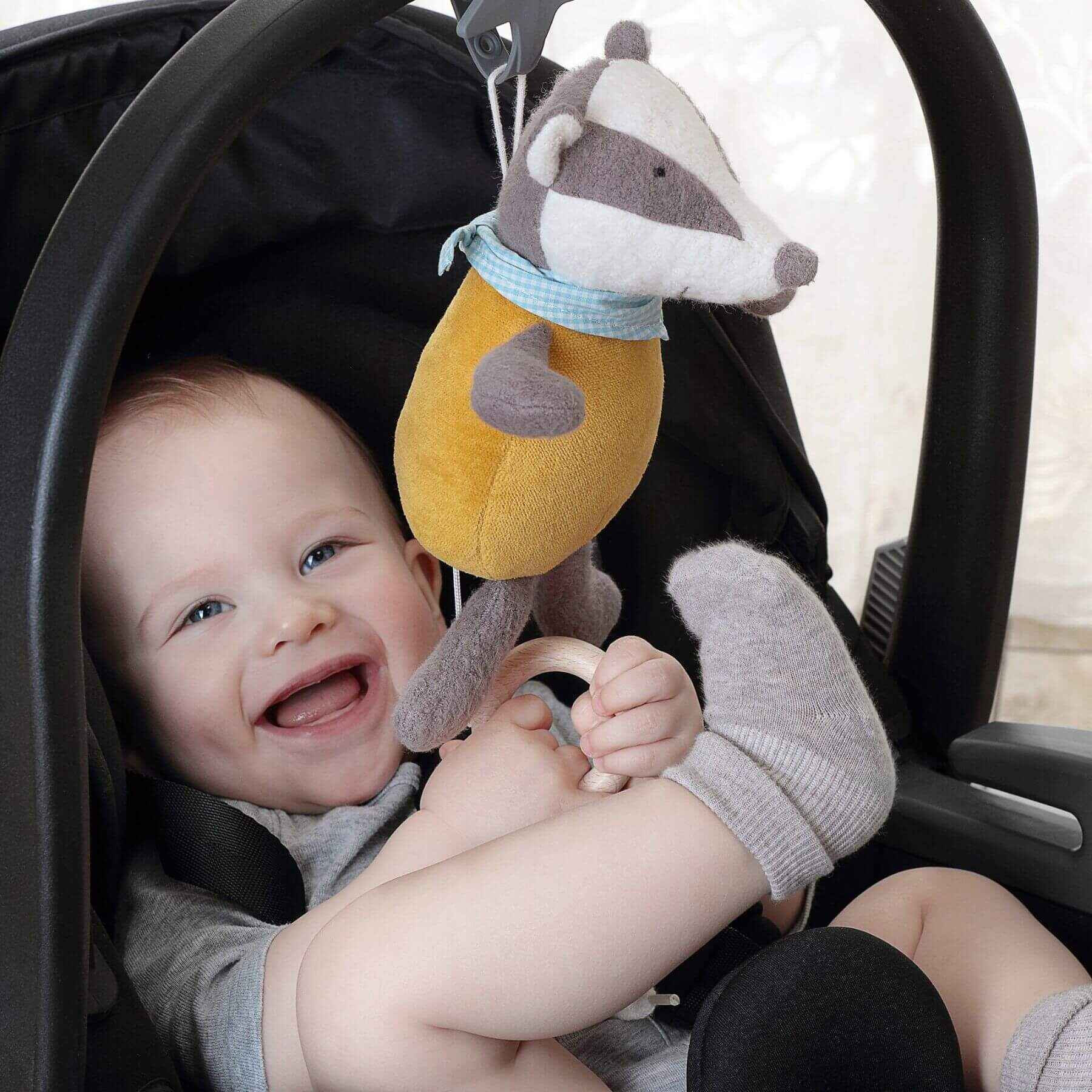 Baby in stroller, playing sigikid Organic Badger Musical Toy