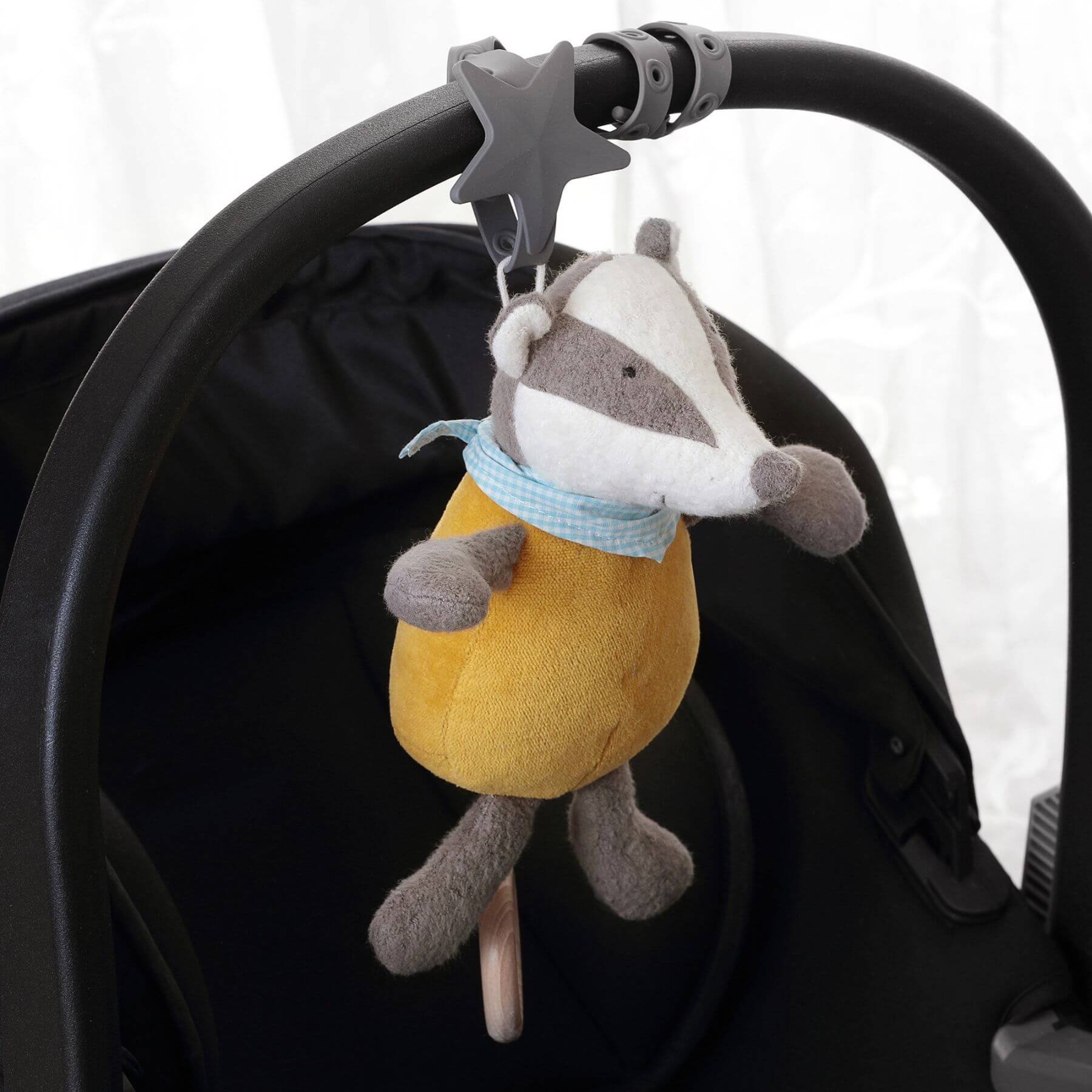 sigikid Organic Badger Musical Toy hanging on stroller