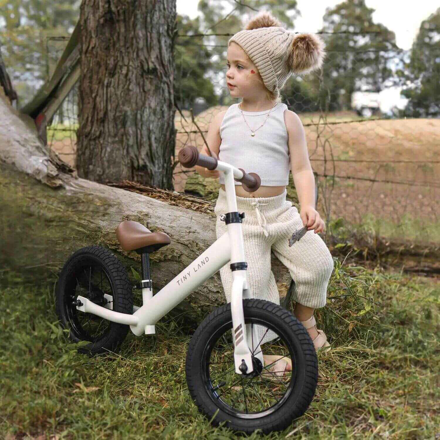 Boy Standing next to Tiny Land® Balance Bike - Milky White