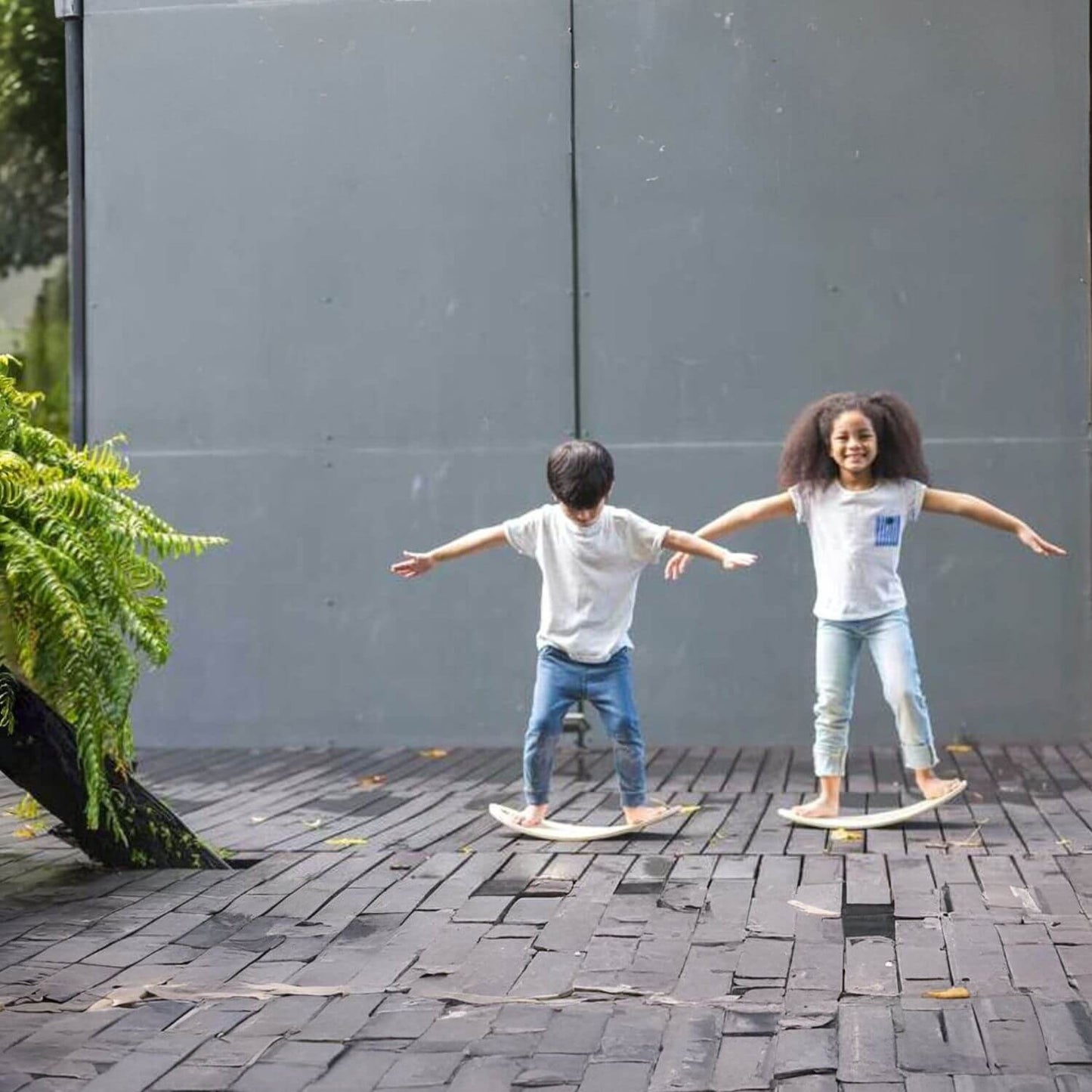 Two Kids Standing on PlanToys Balance Board