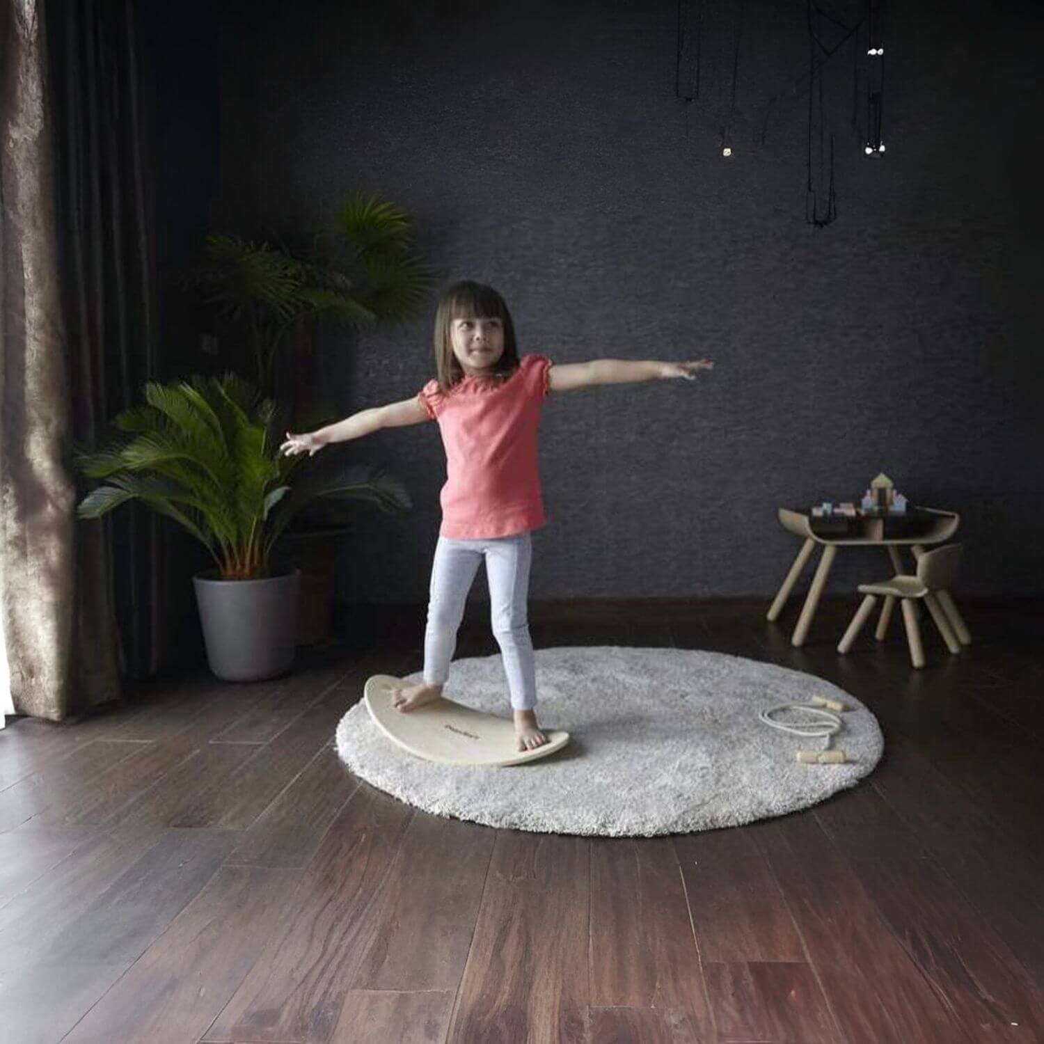 Girl Standing on PlanToys Balance Board