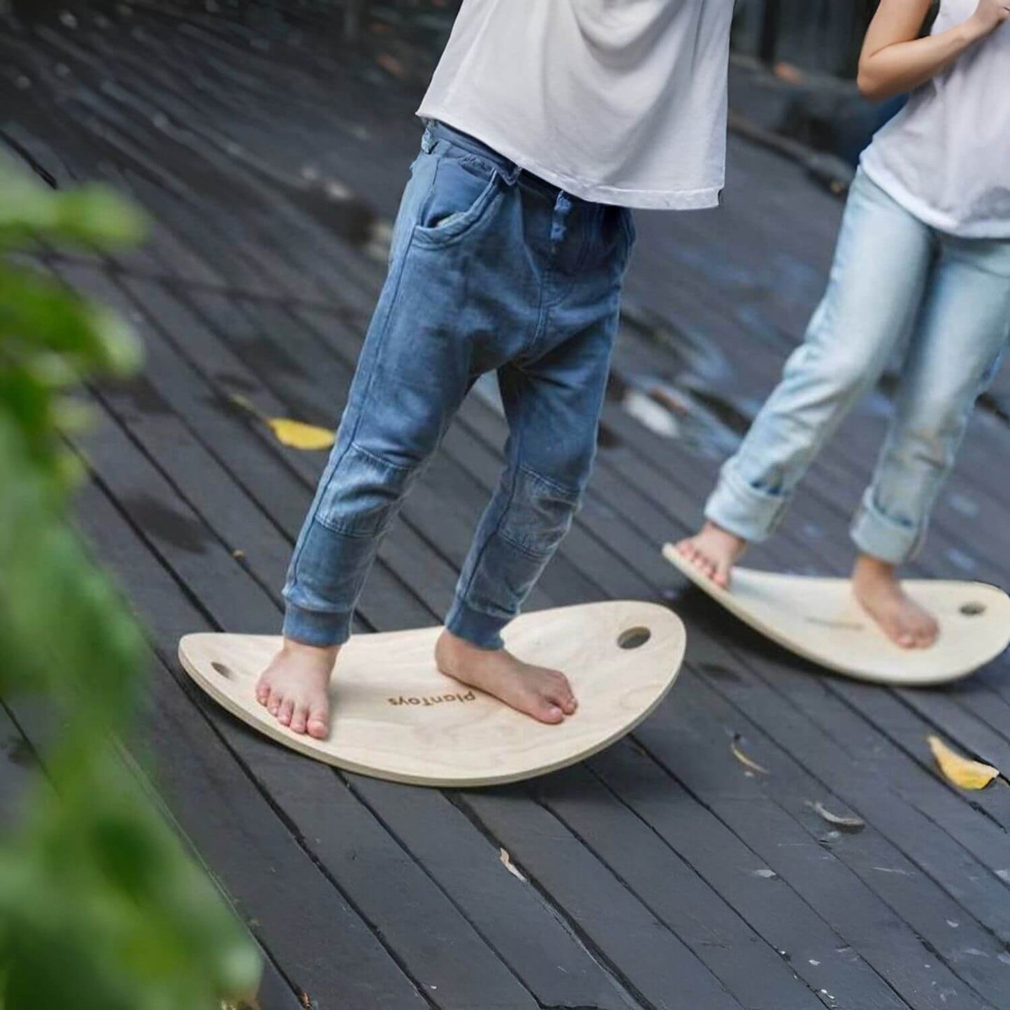 Kids Standing on PlanToys Balance Board