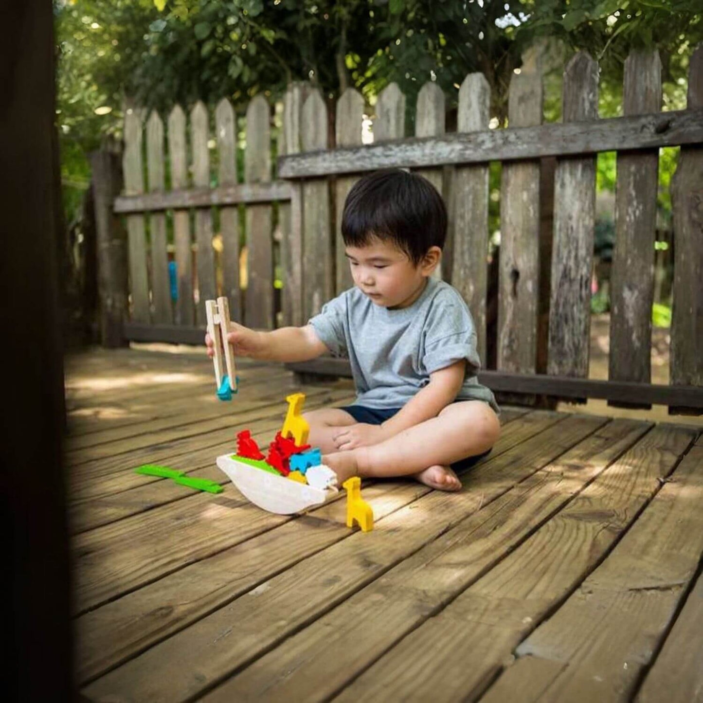 Boy Playing PlanToys Balancing Boat