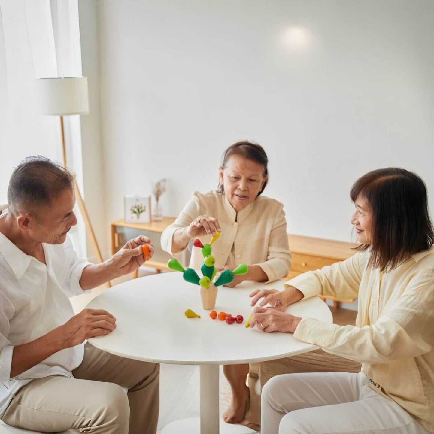 Parents Playing PlanToys Balancing Cactus