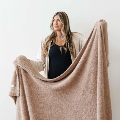 Woman holding Saranoni Bamboni® Throw Blanket against a white background