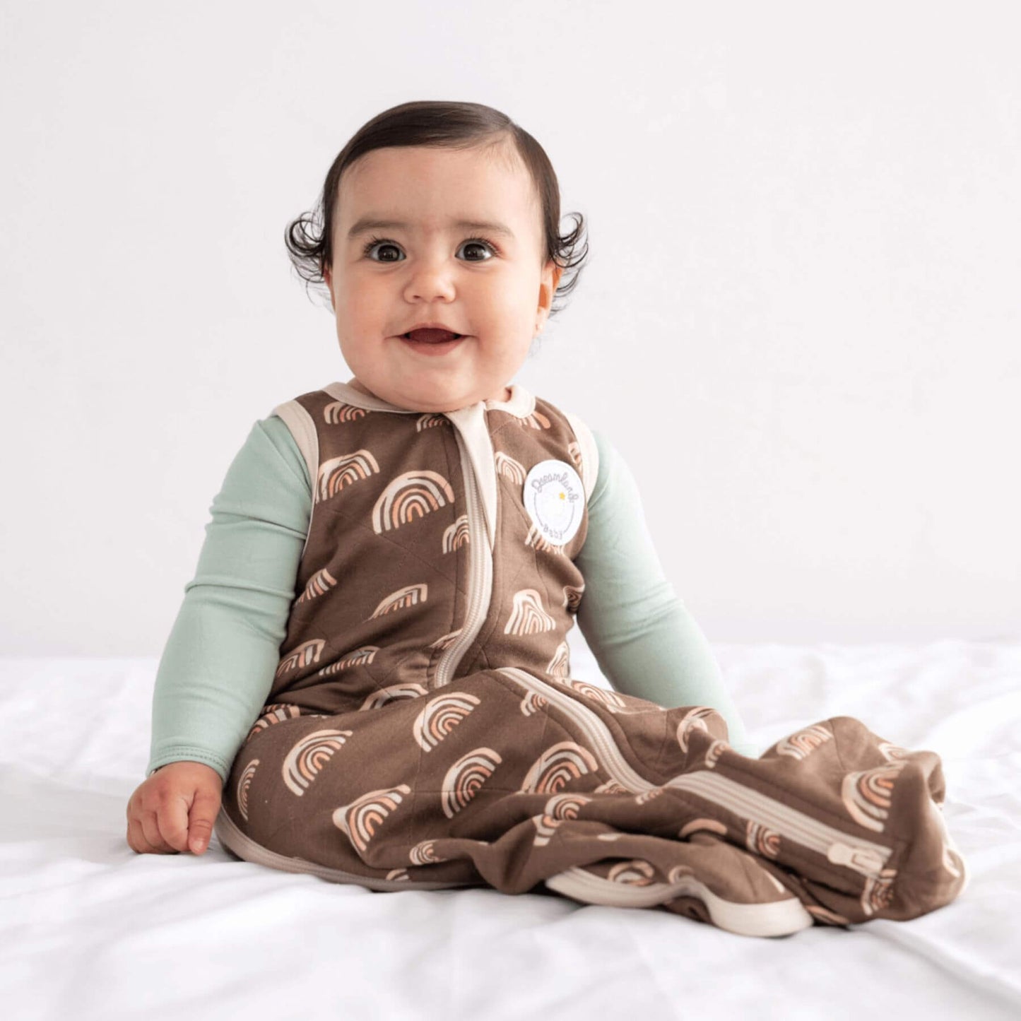 Kid in Bamboo Classic Sleep Sack - Hot Air Ballmoons, sitting on bed