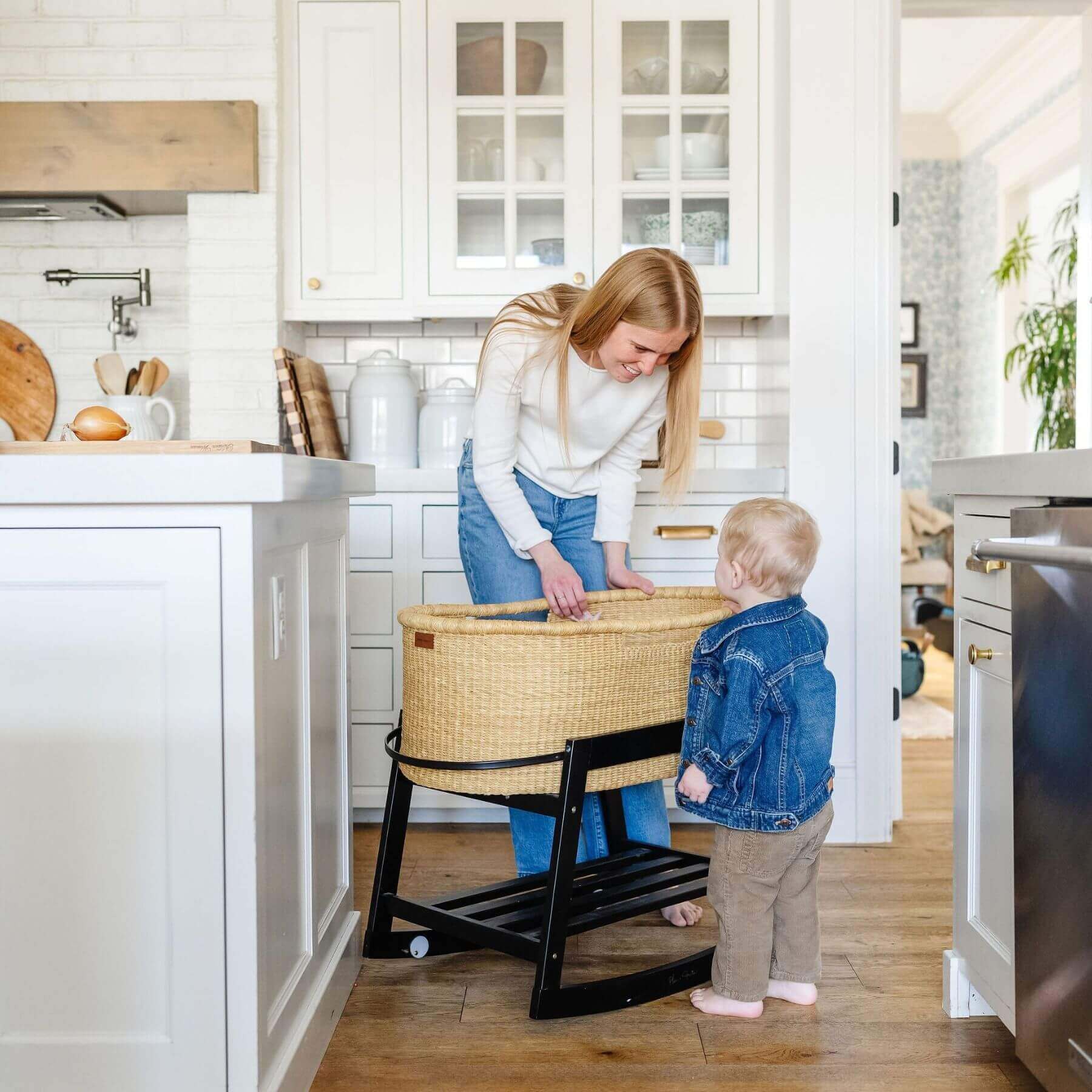 Woman and child in a kitchen with African Moses Basket No Hood Inset Handle