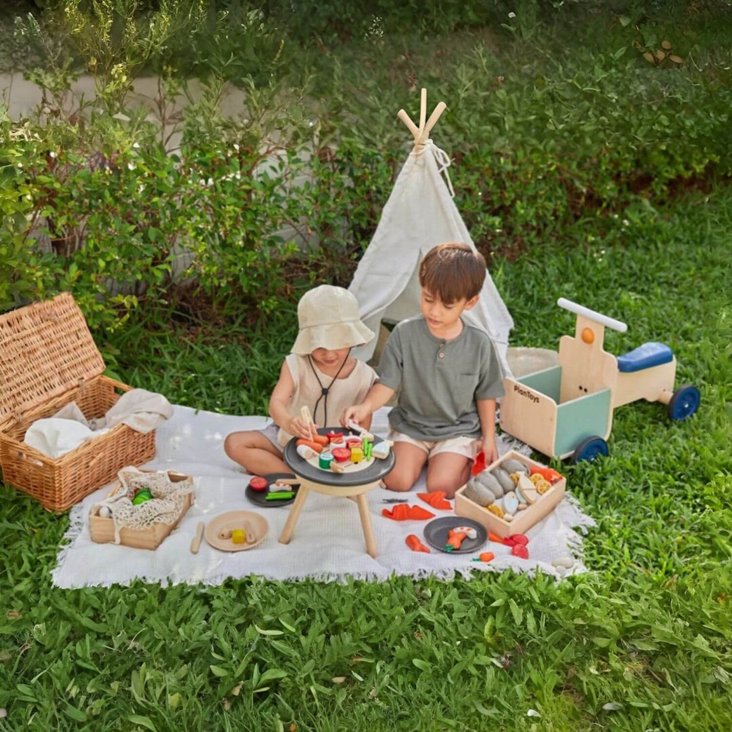 Kids Playing PlanToys BBQ Playset