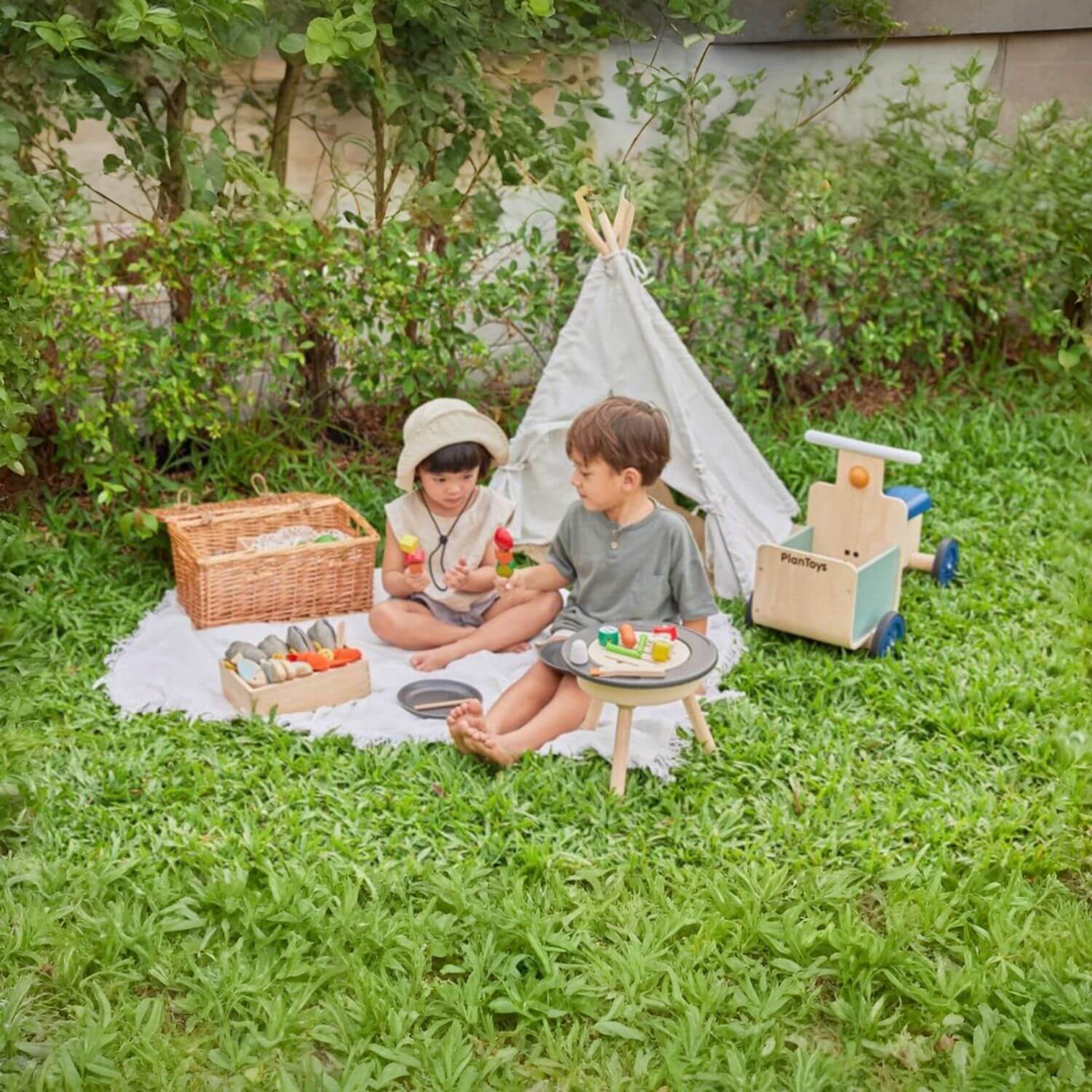 Kids Playing PlanToys BBQ Playset